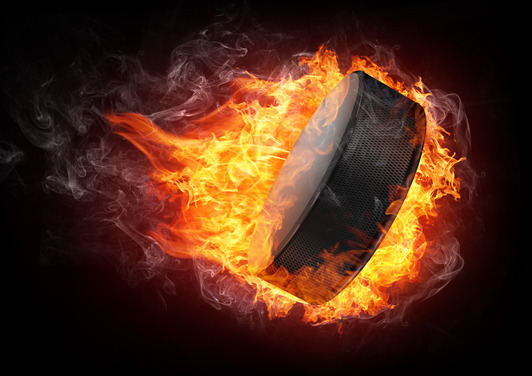 Hockey Puck in fire Isolated on Black Background